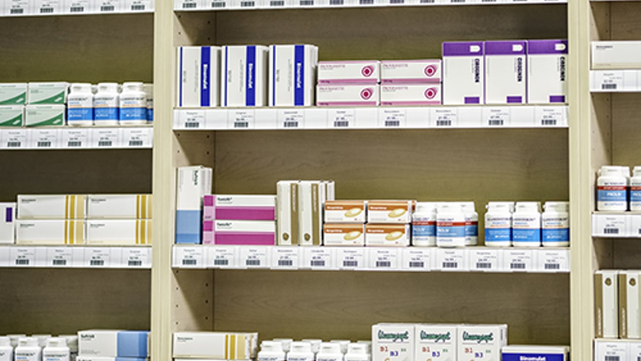 Pill bottles on a pharmacy shelf. 