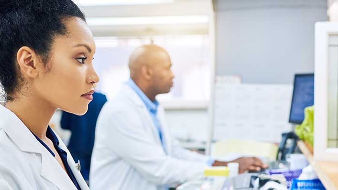 A pharmacist at a computer.