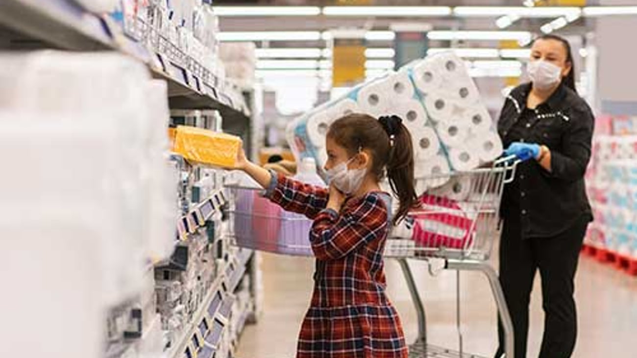 a little girl standing in front of a building