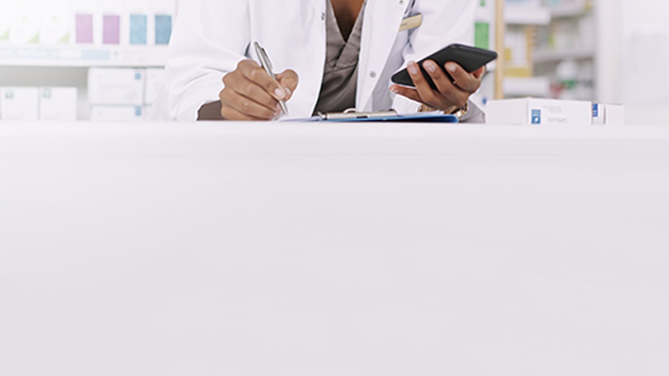 Pharmacist with a cellphone.