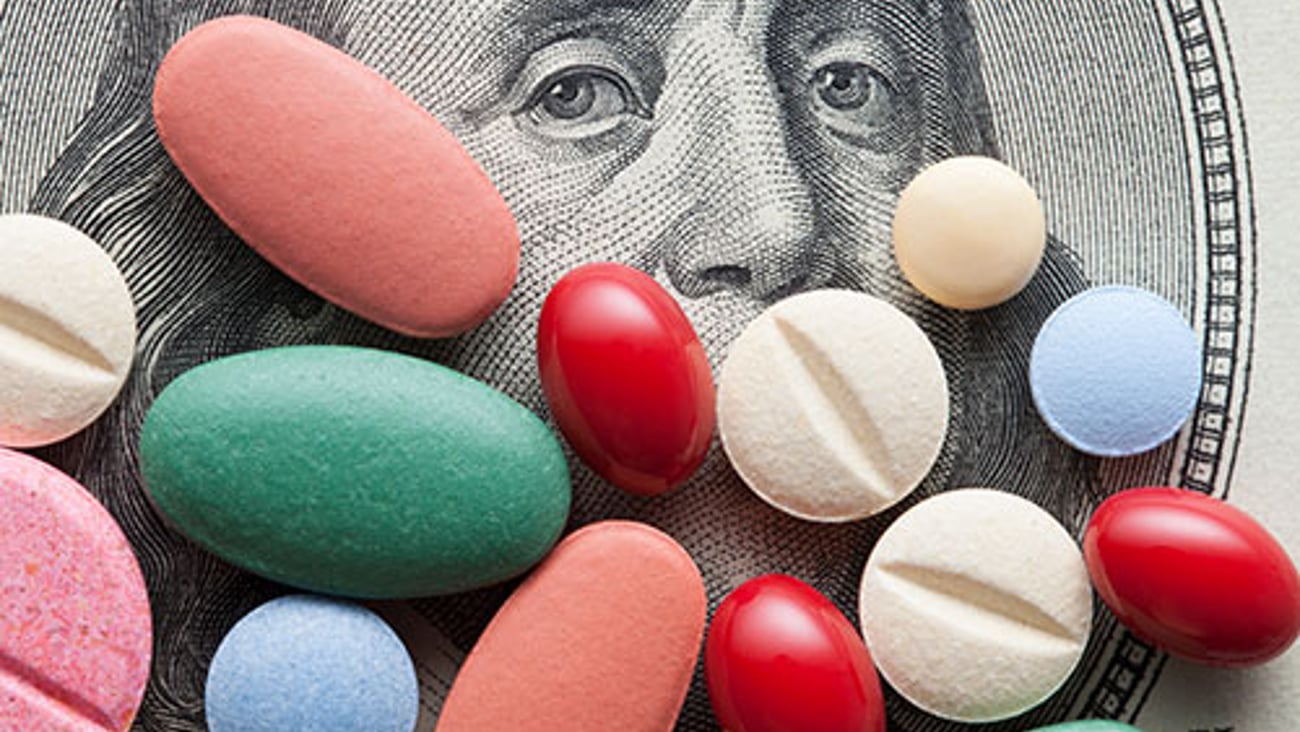 Colorful pills on top of money.