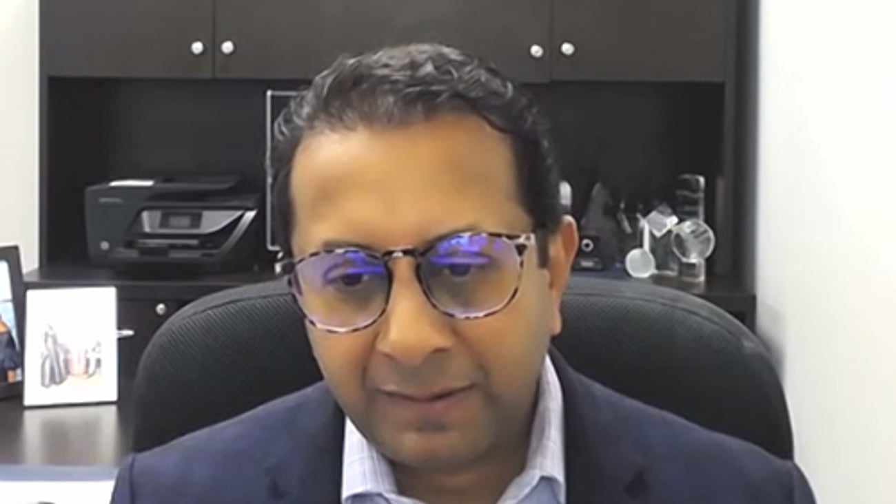 Nimesh Jhaveri wearing glasses and smiling at the camera