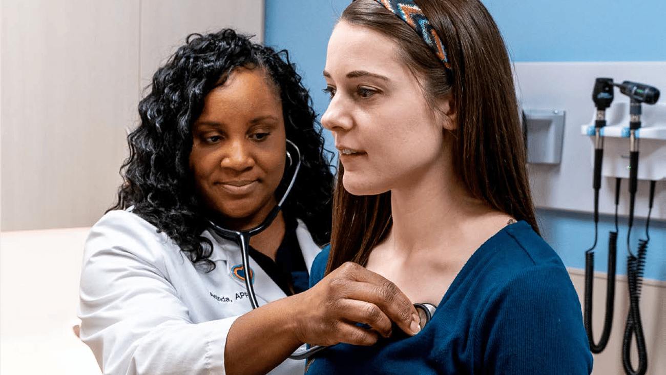 Nurse practitioner treating young woman