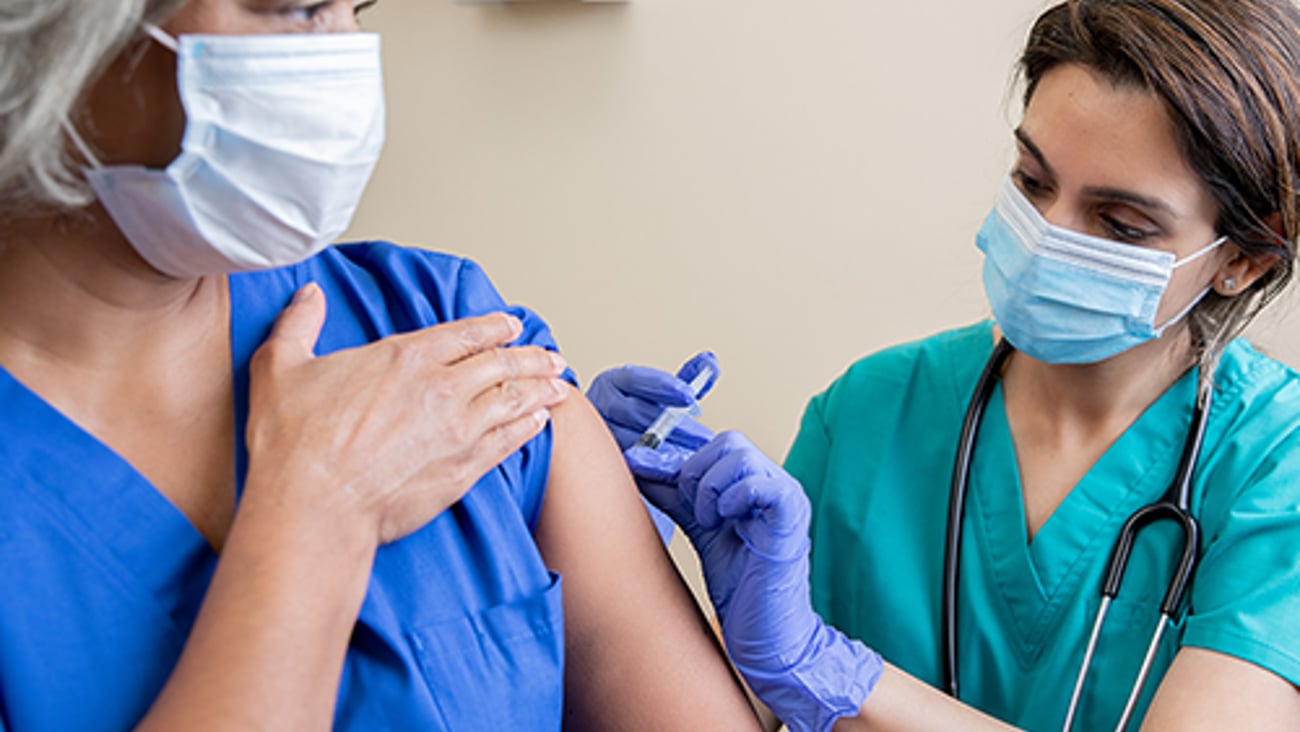 A healthcare worker giving a vaccine