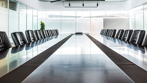 An empty boardroom with chairs.