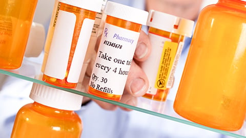 Pill bottles on a pharmacy shelf. 