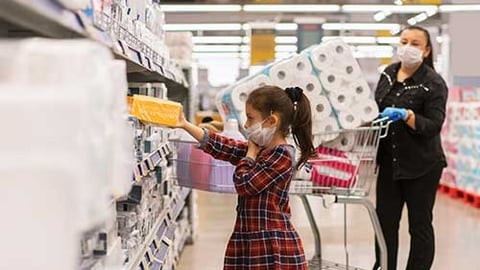 a little girl standing in front of a building