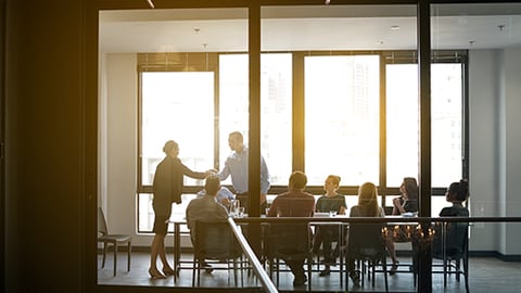 A boardroom with people in it.