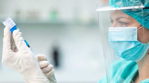 A healthcare worker  preparing a vaccination.