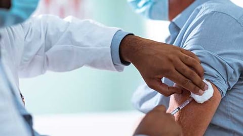 Healthcare worker giving vaccine.