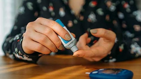 A person checking their blood glucose level.