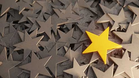 A gold star among white stars. 