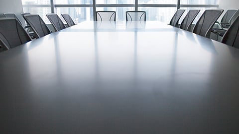 A boardroom with empty seats.