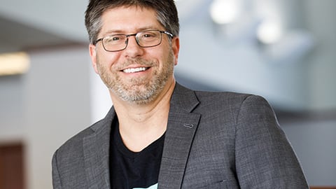 Jeff Lucas, a man leaning against a railing and smiling