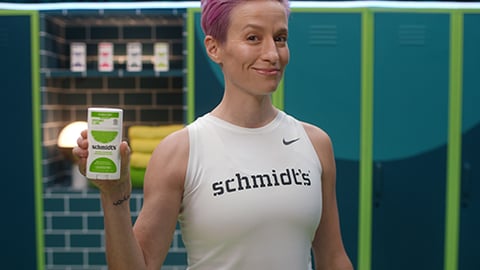 Megan Rapinoe standing in front of a fence