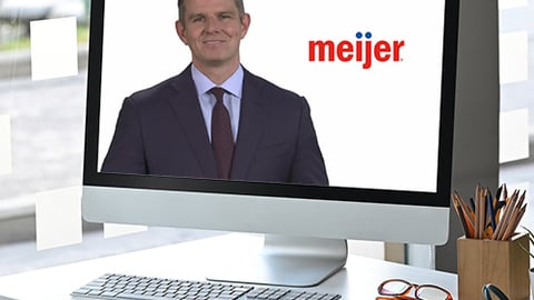 a man sitting at a desk in front of a computer screen