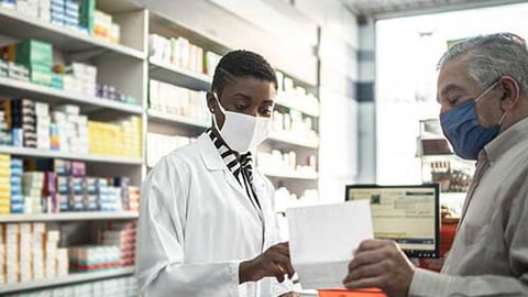 a pharmacist with a patient.