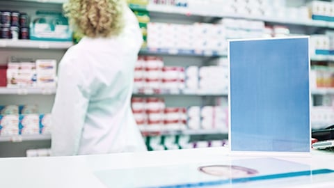 A female pharmacist in a stockroom.