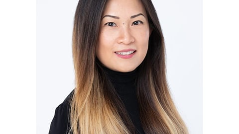 a close up of a woman who is smiling and looking at the camera