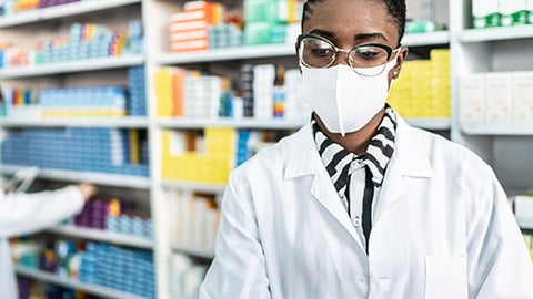 A pharmacist at a computer.