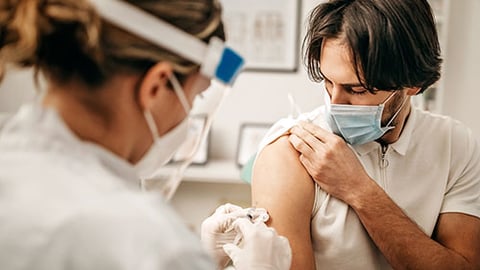 A healthcare worker giving a vaccine