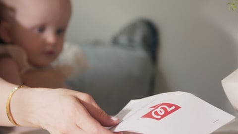 a hand holding a baby