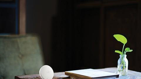 a vase sitting on top of a wooden table