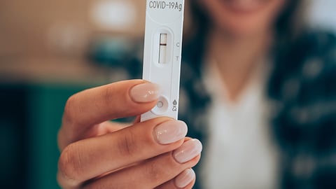 a hand holding a remote control