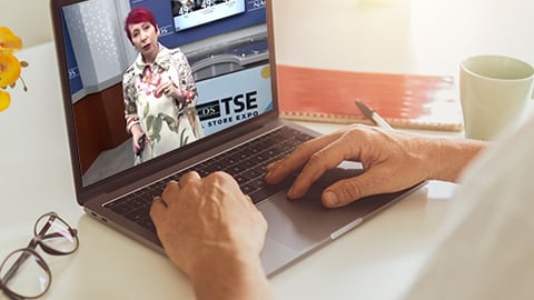 a person sitting at a table using a laptop