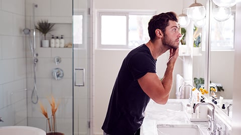 a person standing in front of a mirror posing for the camera