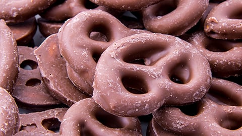 a close up of a doughnut and a chain link fence