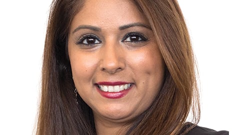 a close up of a woman who is smiling and looking at the camera