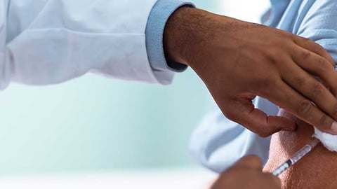 Pharmacist giving a vaccine.