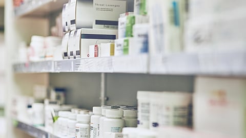 A pharmacy shelf with medications.