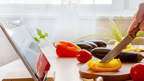 a person sitting at a table with a bowl of fruit