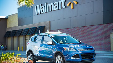 a blue car parked in front of a building