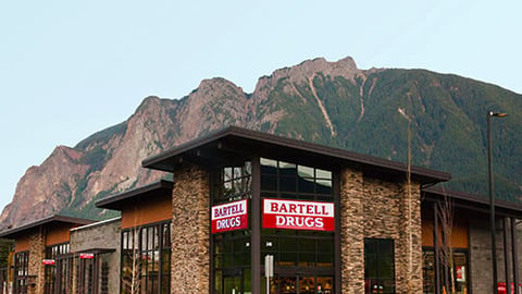 a large brick building with a mountain in the background