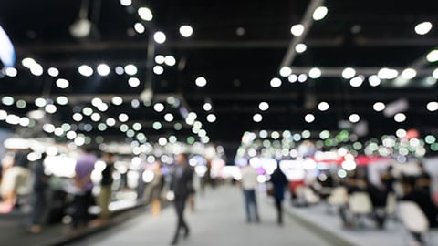 People walking at an exhibit hall. 