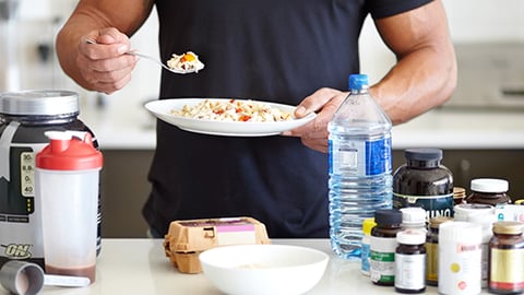 a person sitting at a table with food and drinks