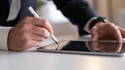 a person sitting at a table using a laptop