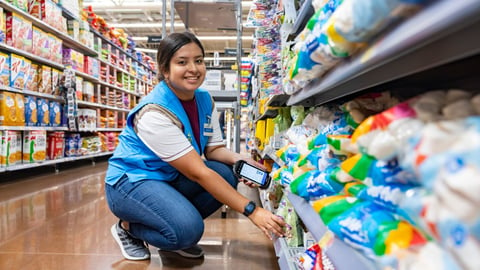 Walmart employee stocking shelves