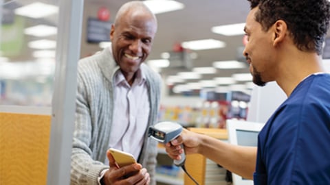 Man checking out with phone