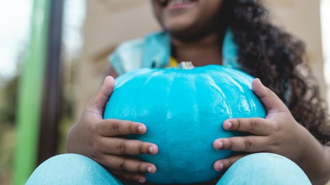 girl-holding-a-blue-pumpkin