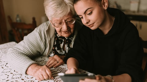 elderly woman and younger woman together at a table