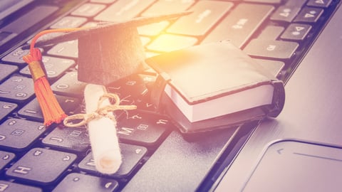 Online learning or e-learning and online graduate certificate program concept : Black graduation cap, diploma on a laptop computer keyboard, depicts distant learning can be done via cyber or internet; Shutterstock ID 1033073659