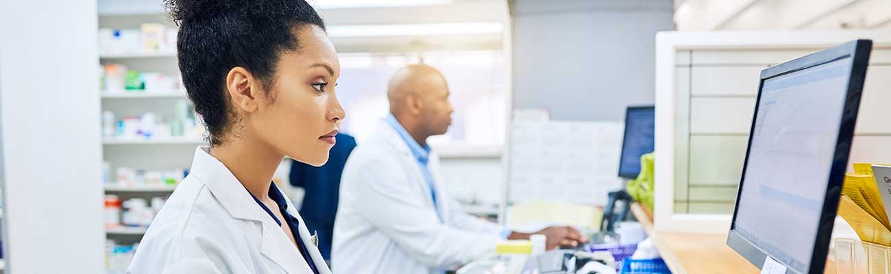 A pharmacist at a computer.