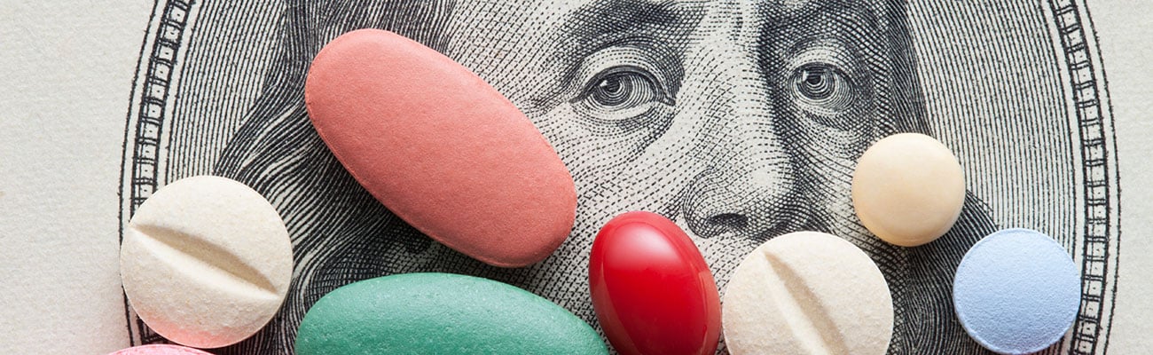 Colorful pills on top of money.