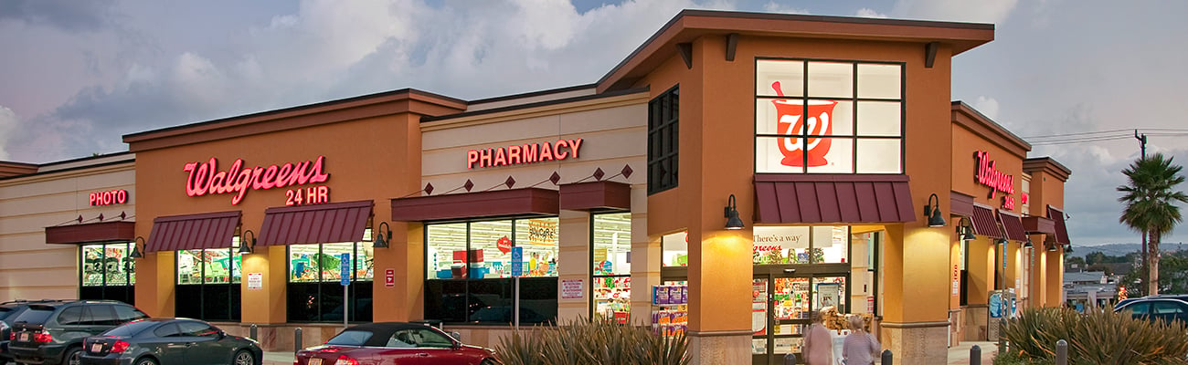 a group of people walking in front of a store