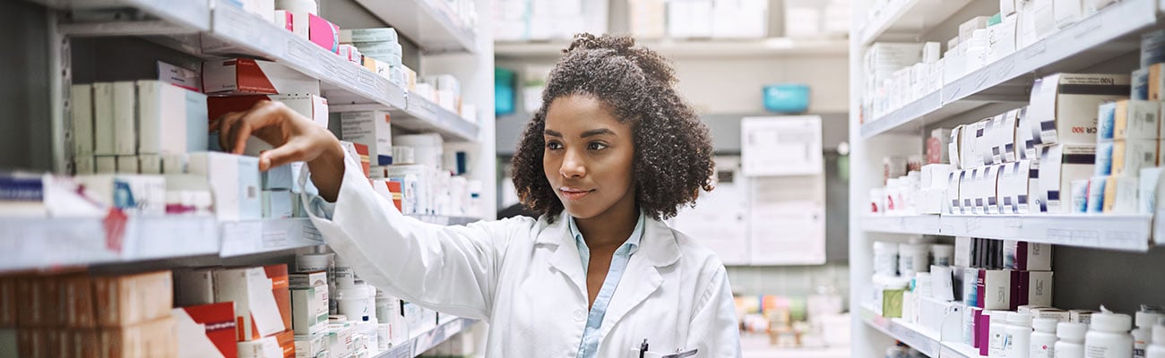 A female pharmacist in a stockroom.