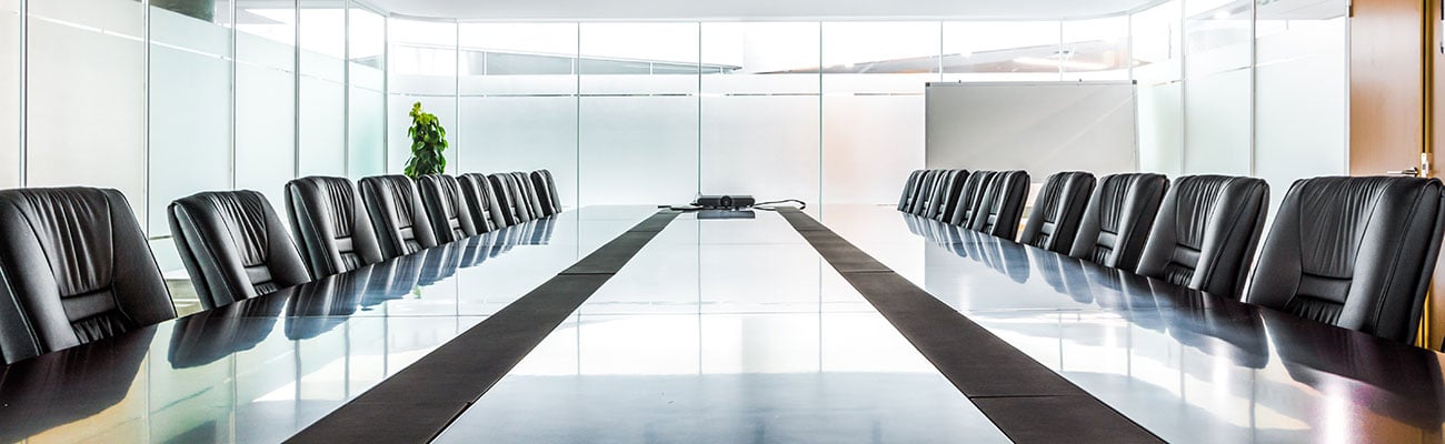 a board room filled with furniture and a large window